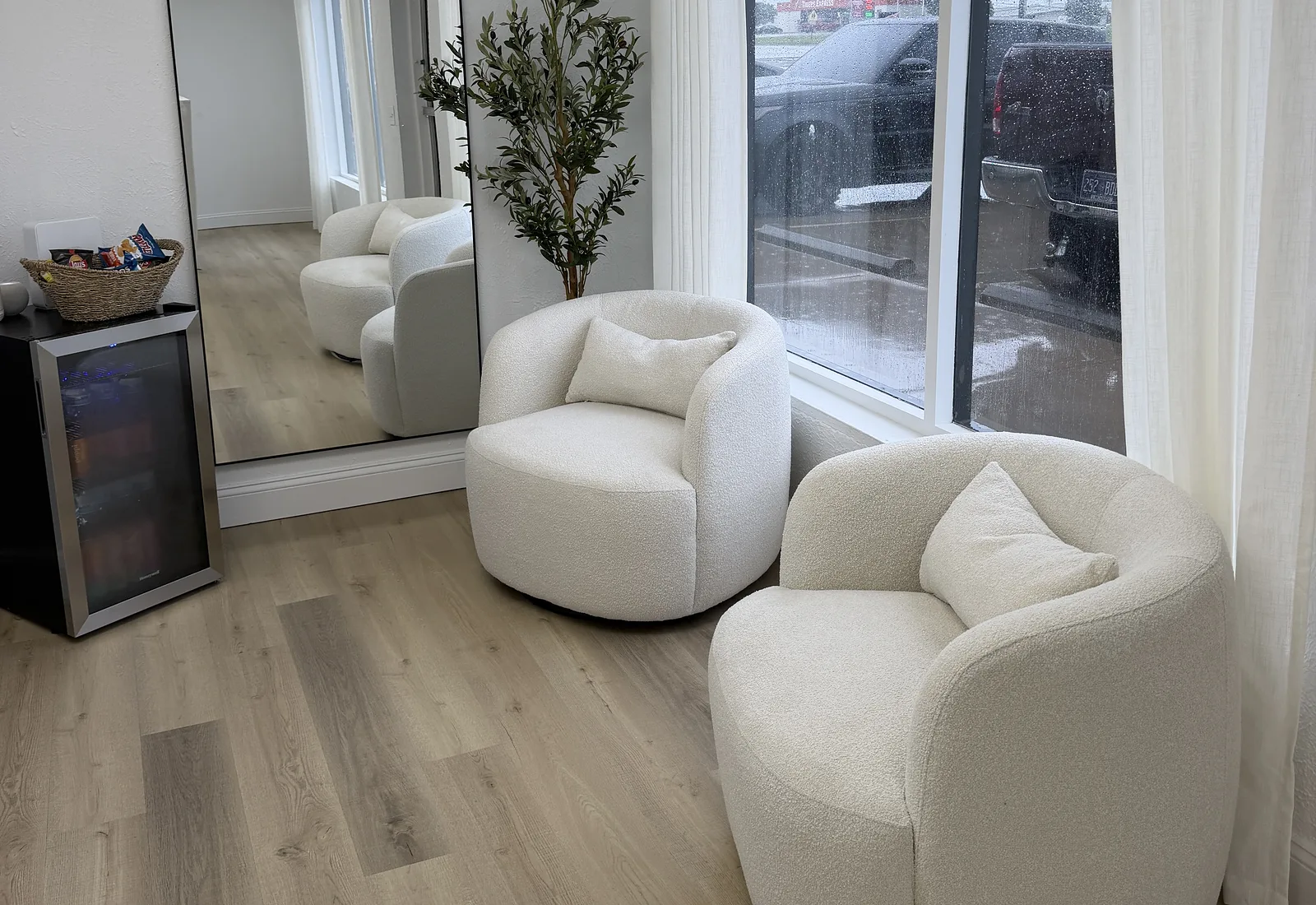Soft seating and mirror inside SĒK Esthetics + Wellness